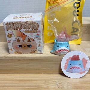 Cute Blue Shark Figurine holding pink crystals